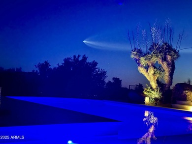 Nestled against a dramatic mountain backdrop and framed by