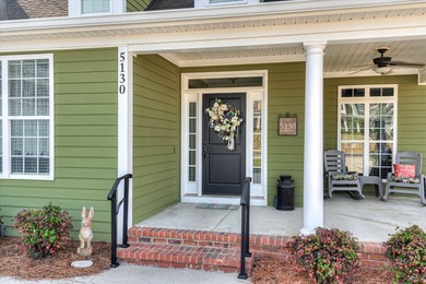 This exquisite home in the prestigious Windmill Plantation