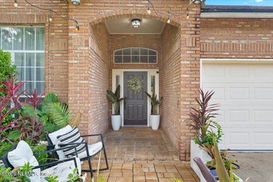 Set on a peaceful waterfront lot in the gated community of The - photo 2
