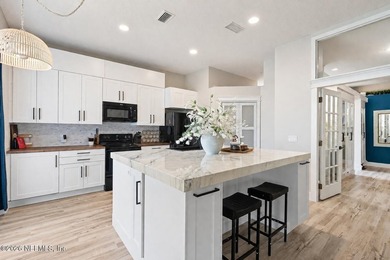 Set on a peaceful waterfront lot in the gated community of The - photo 4