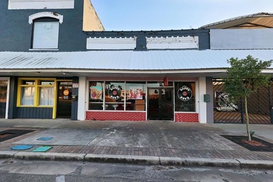 Located on the courthouse square in historic Perry, this - photo 1