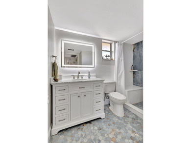 A brand-new bathroom, consistent flooring & water view - photo 12