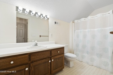 This spacious coastal home sits in the middle of a generous