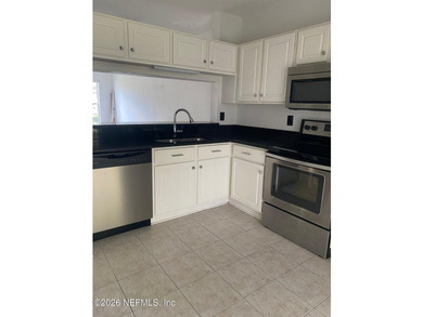 This spacious end-unit condo offers an inviting open floor plan - photo 7