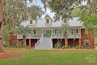 Gracefully set along sweeping marsh-front vistas, this - photo 4