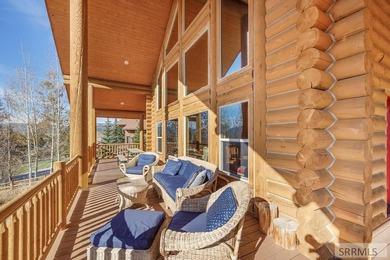 Perched on a half-acre of pristine land, this full-log retreat - photo 12