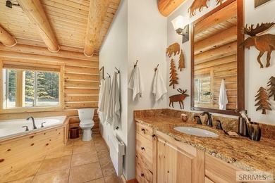 Perched on a half-acre of pristine land, this full-log retreat - photo 16