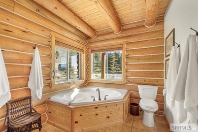 Perched on a half-acre of pristine land, this full-log retreat - photo 17