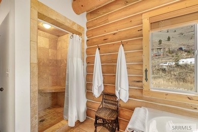 Perched on a half-acre of pristine land, this full-log retreat - photo 18