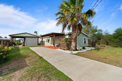 Don't miss this canal-front, Texas gem in Copano Cove. Framed by - photo 1