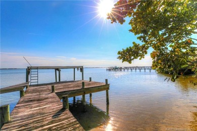 Framed by swaying palms and endless water views, this estate - photo 1