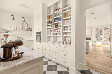 Nestled on a sprawling one-acre lot within the prestigious gated - photo 12