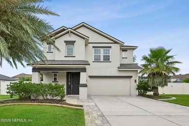 Perfectly positioned on a massive corner lot in the highly - photo 1