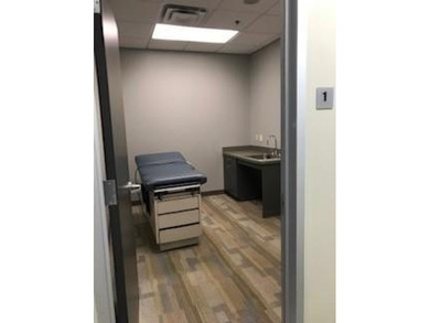 The first floor has a vestibule entrance with a stairwell and