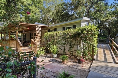 Framed by a canopy of mature trees and lush landscaping, this - photo 1