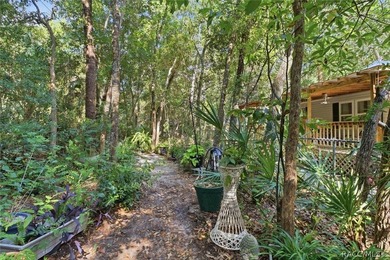 Framed by a canopy of mature trees and lush landscaping, this - photo 3