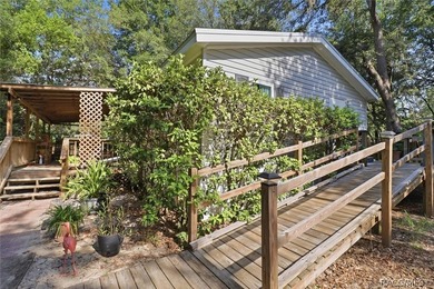 Framed by a canopy of mature trees and lush landscaping, this - photo 4
