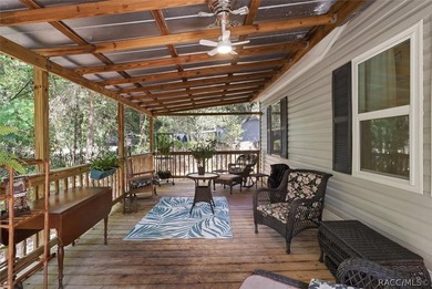 Framed by a canopy of mature trees and lush landscaping, this - photo 5