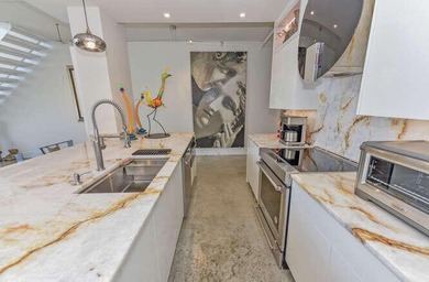 The main level offers a newer custom kitchen with marble - photo 14