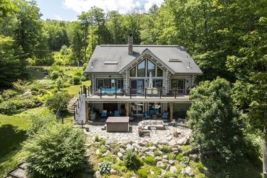 Experience exceptional lakeside living in this custom-built log - photo 1