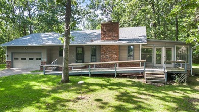 Come home to this charming house nestled in the woods on over an - photo 1