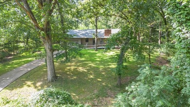 Come home to this charming house nestled in the woods on over an - photo 2
