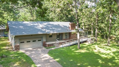 Come home to this charming house nestled in the woods on over an - photo 4