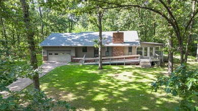 Come home to this charming house nestled in the woods on over an - photo 5