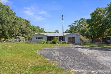 Nestled on approximately 1.6 acres in Homosassa, this charming - photo 1