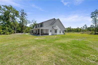 Welcome home to this stunning custom-built farmhouse homestead - photo 4