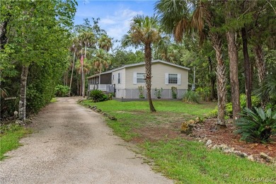 Tucked away on a beautiful wooded 1-acre waterfront lot in the - photo 1