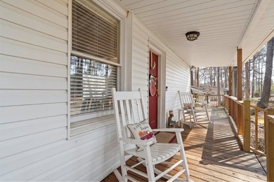 Tucked along the water's edge, this charming rustic cottage is - photo 2