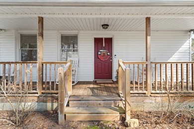 Tucked along the water's edge, this charming rustic cottage is - photo 3