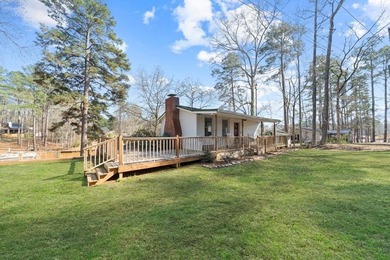 Tucked along the water's edge, this charming rustic cottage is - photo 4