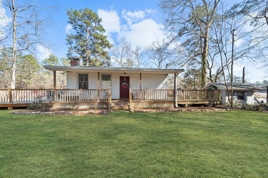 Tucked along the water's edge, this charming rustic cottage is - photo 5