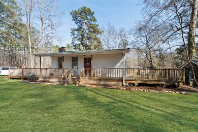 Tucked along the water's edge, this charming rustic cottage is - photo 6