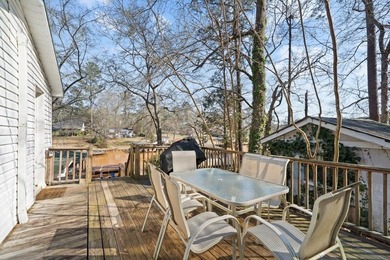 Tucked along the water's edge, this charming rustic cottage is - photo 8