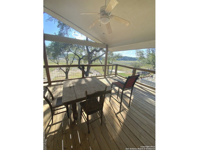 Nestled along the serene shores of Medina Lake, this charming - photo 4