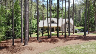 Peaceful Luxury awaits on a 1.4-acre lot in the gated community