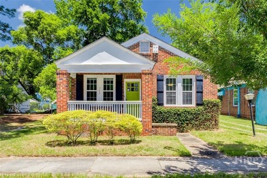 Built in 1923, this charming brick bungalow delivers the - photo 1