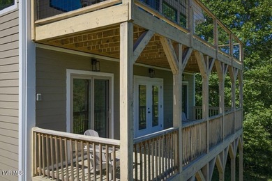 Perched above the crystal-clear waters of Watauga Lake, this - photo 41