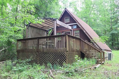 Lots of potential in this cute A-frame home tucked away on a - photo 1