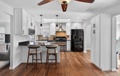 Welcome to this beautifully maintained waterfront ranch in the