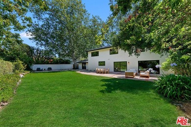Nestled on a rare private flat lot along Sicomoro Drive in the - photo 43