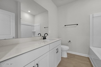 This spacious townhome boasts a first-floor primary suite, and - photo 25