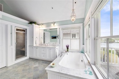Perched at the water's edge, 19 Teal Drive is a custom-built - photo 33