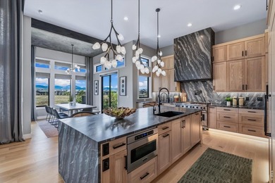 Backing breathtaking water and mountain views, this stunning - photo 10