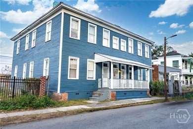 This well-maintained four-unit property offers investors a rare - photo 1