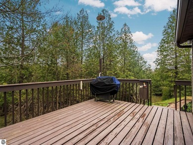 Tucked away on 8+ wooded acres along the Manistee River and - photo 24