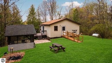 Tucked away on 8+ wooded acres along the Manistee River and - photo 29